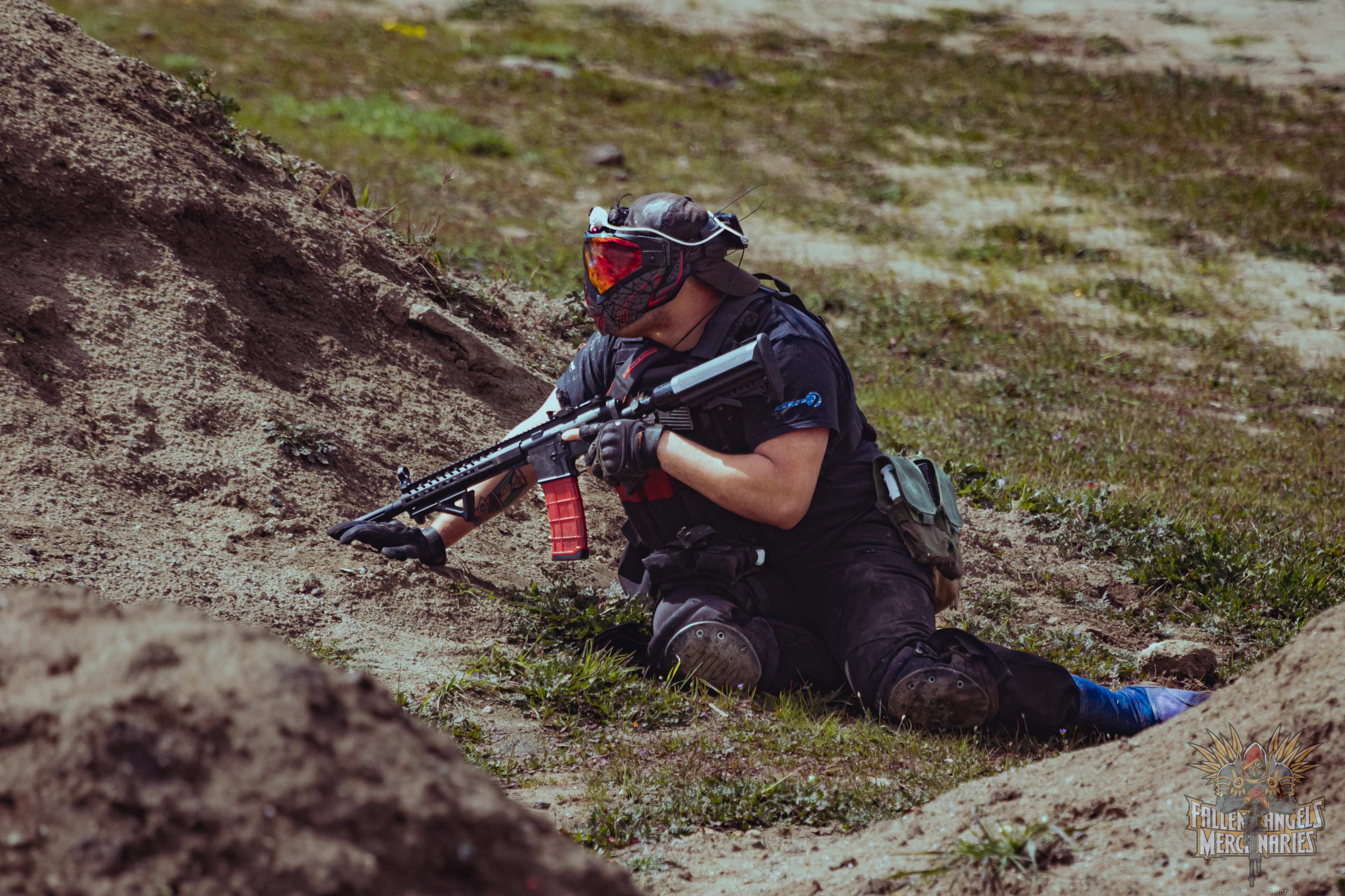Fallen Angels Mercenaries player crouched and aiming during gameplay